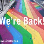 A rainbow coloured road with the event title We're Back superimposed